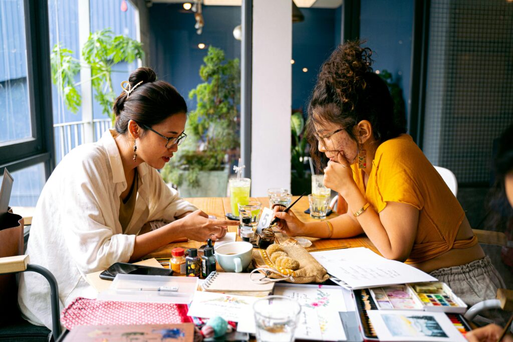 Two women working together sitting down